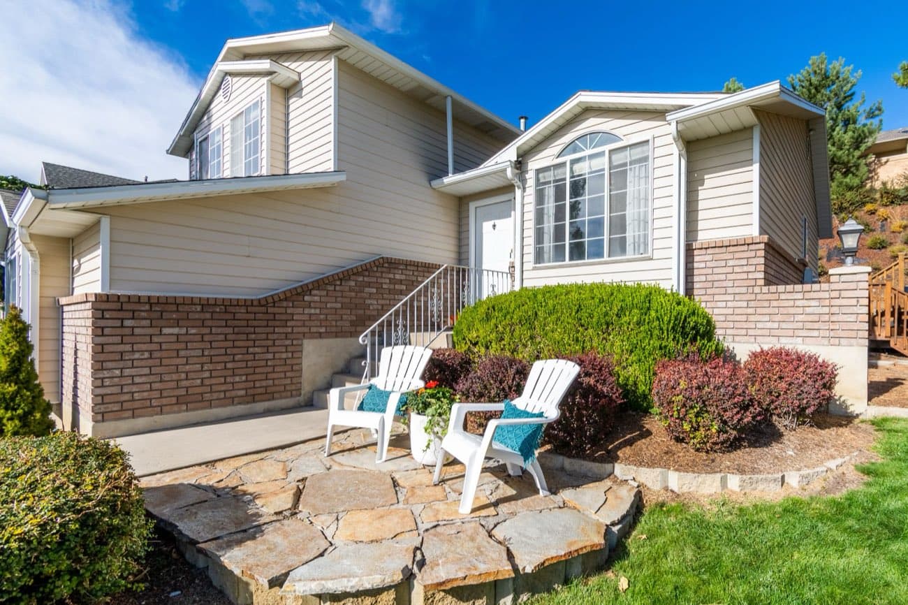 A house with a small front patio and two chairs